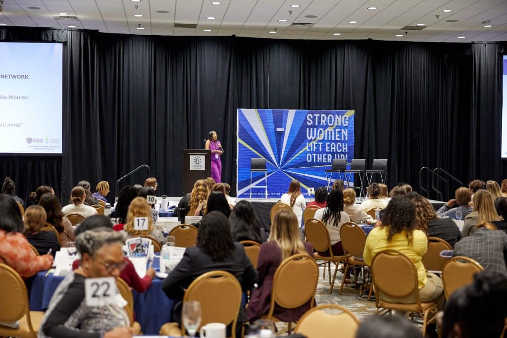 Kendra Bulluck-Major speaks on stage at the summit