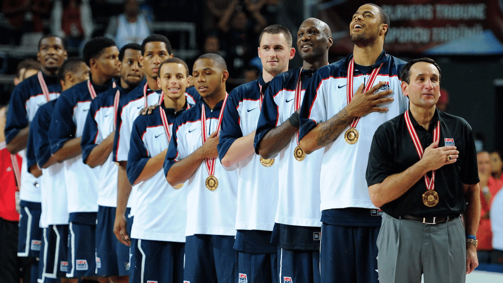 Coach K and Team USA with gold medals